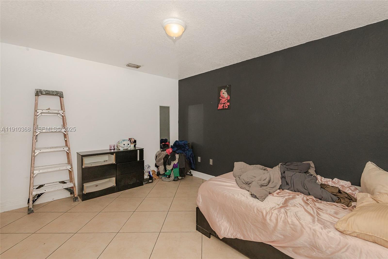 18890 Southwest 184th Street Miami, FL 33187 - Photo 27 of 37 a bedroom with a bed and cabinets