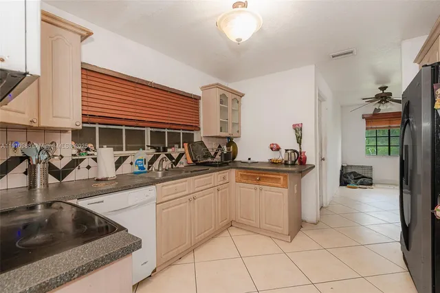 a kitchen with granite countertop a sink and cabinets