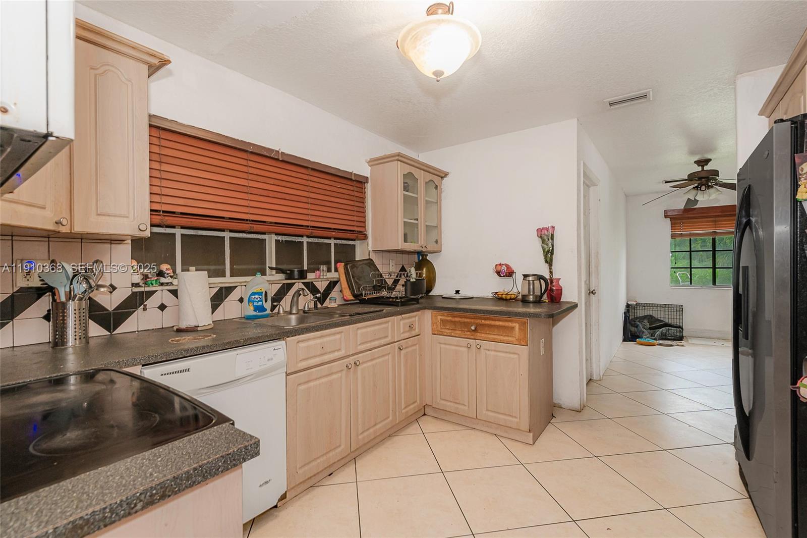 18890 Southwest 184th Street Miami, FL 33187 - Photo 3 of 37 a kitchen with granite countertop a sink and cabinets