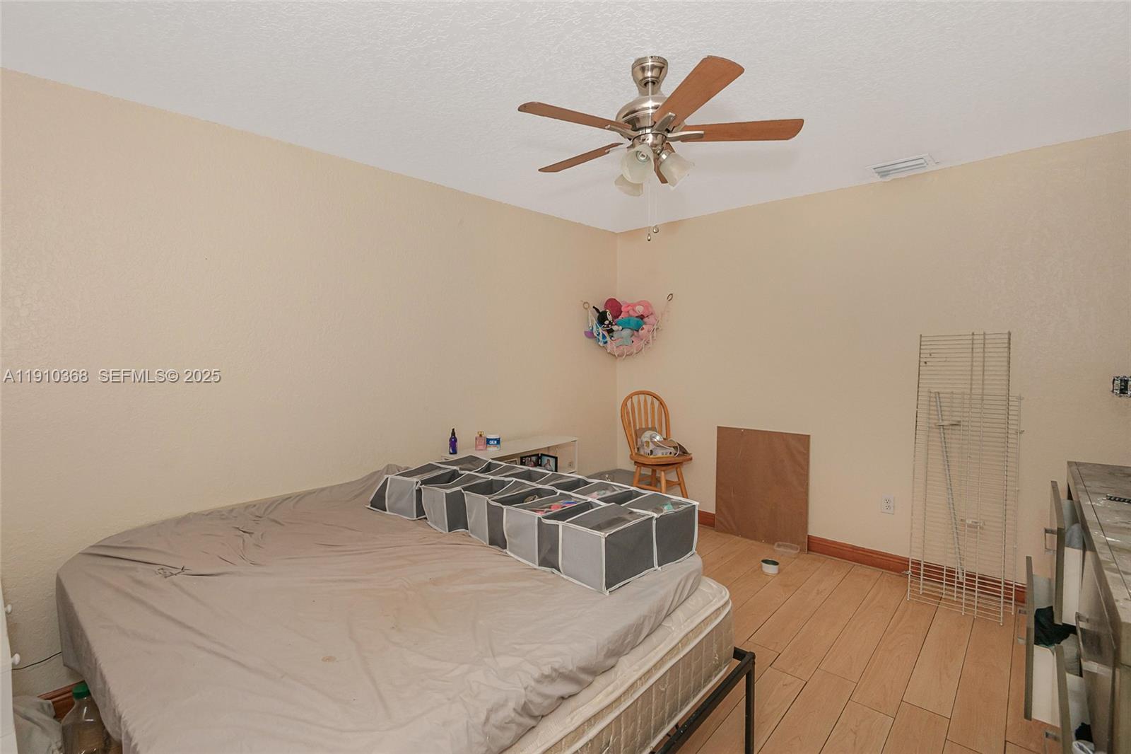 18890 Southwest 184th Street Miami, FL 33187 - Photo 31 of 37 a bedroom with a bed and a chandelier