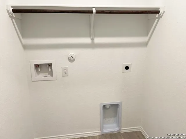 a front view of a house with yard and wooden fence