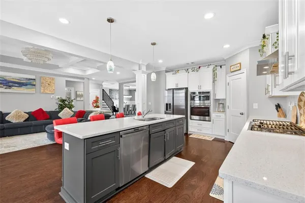 a kitchen with granite countertop white cabinets and a stove
