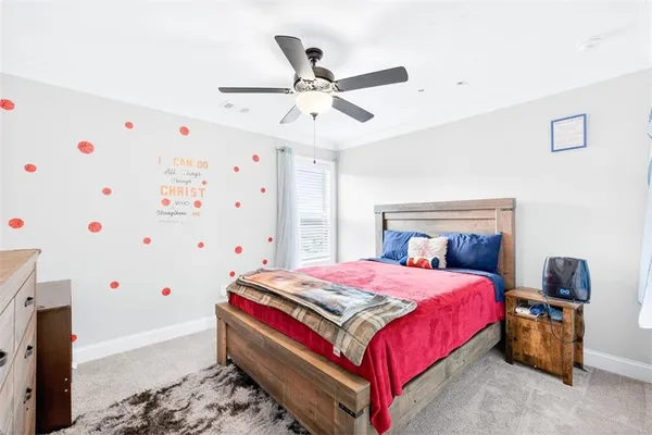 a bathroom with a granite countertop sink a toilet and a shower curtain