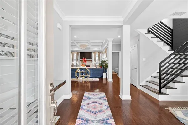 a view of a dining room with furniture and wooden floor