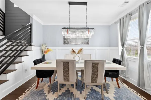 a view of a dining room with furniture window and wooden floor