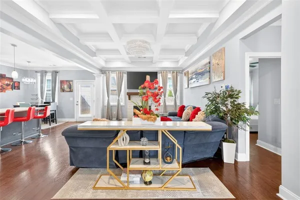 a living room with furniture and kitchen view