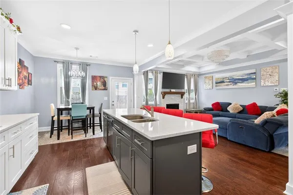 a living room with stainless steel appliances kitchen island furniture and a kitchen view