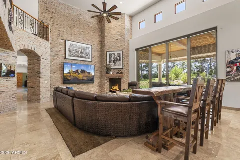 a kitchen with stainless steel appliances granite countertop a stove top oven a dining table and chairs with wooden floor