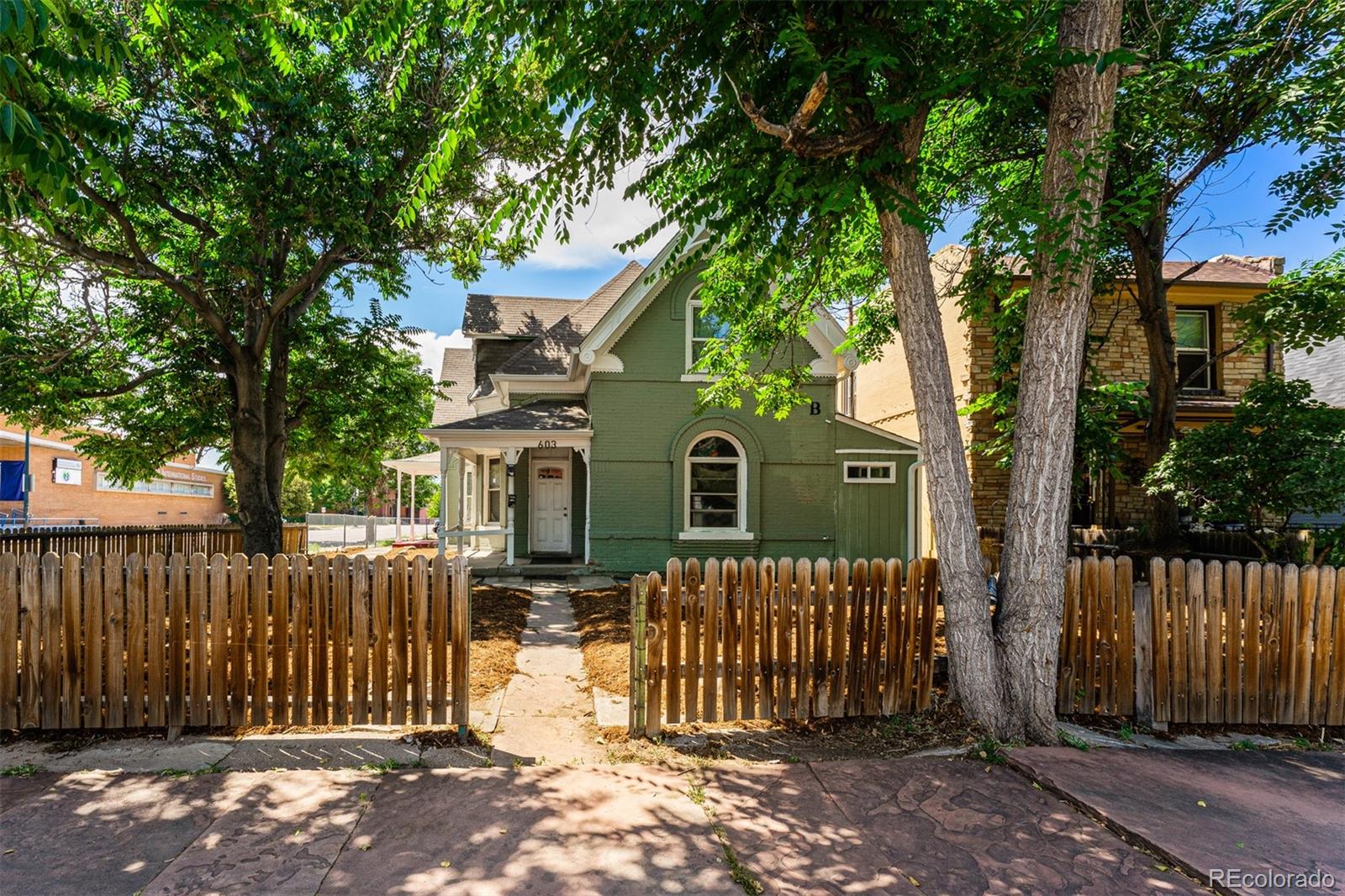 603 Elati Street Denver, CO 80204 - Photo 2 of 12 a front view of a house with a tree