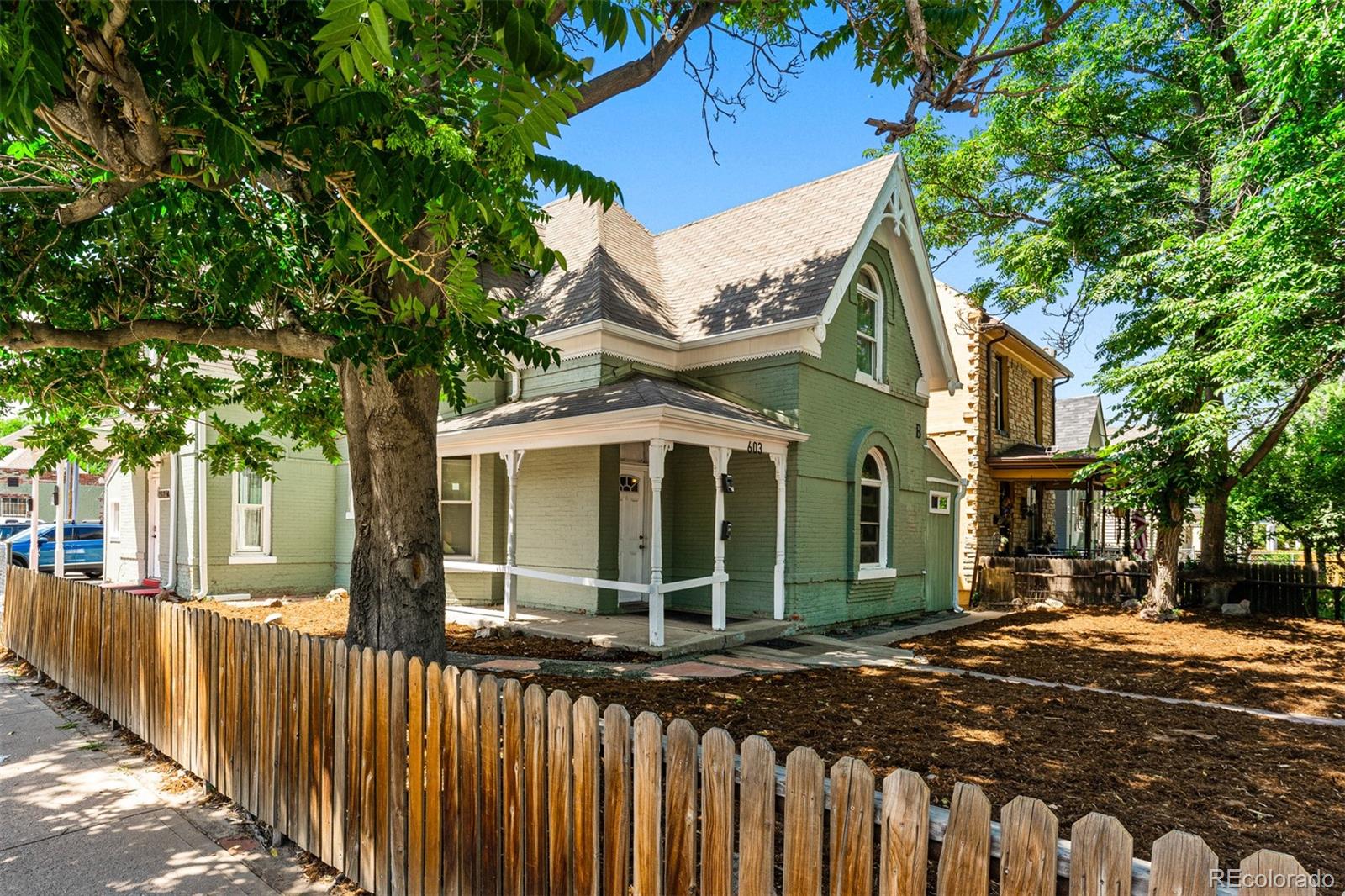 603 Elati Street Denver, CO 80204 - Photo 4 of 12 a front view of a house with a garden