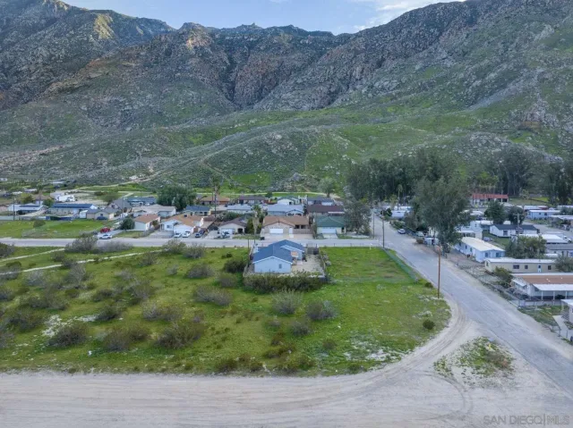 a view of a grassy field with an trees