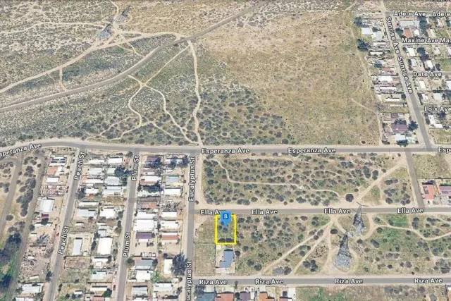 a view of a dry yard with mountains