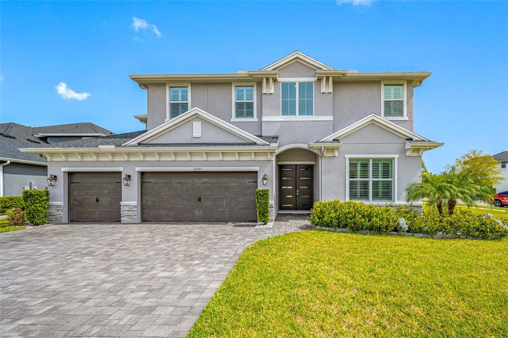 a front view of a house with a yard and garage