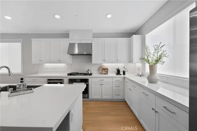 a kitchen with a sink stainless steel appliances and cabinets