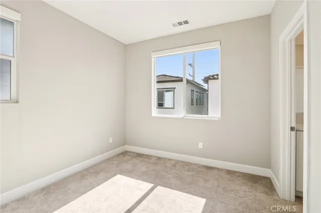 an empty room with windows and closet