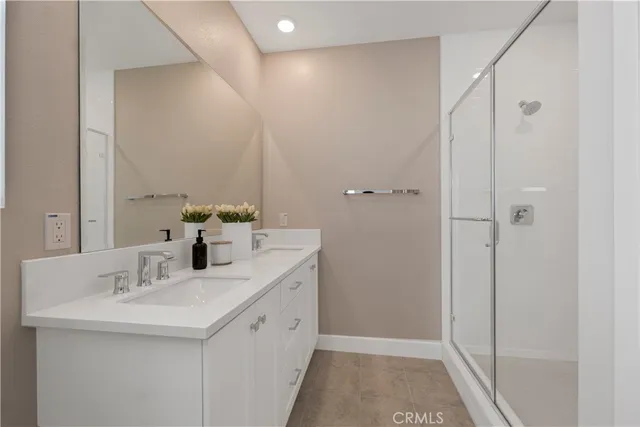 a bathroom with a granite countertop sink a toilet and a large mirror