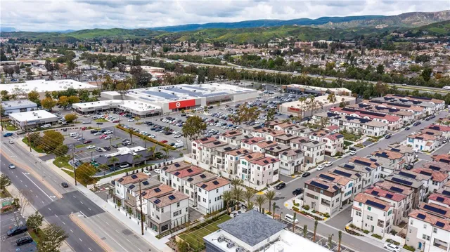 an aerial view of multiple houses with yard