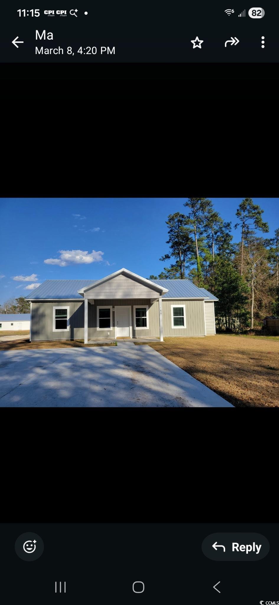 View of front facade with a metal roof and covered porch