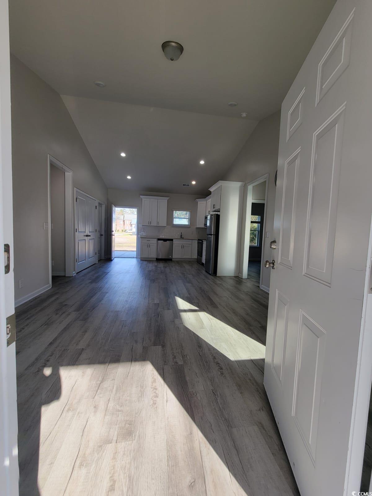 4967 Lyons Lane Longs, SC 29568 - Photo 5 of 9 Unfurnished living room with vaulted ceiling, recessed lighting, and dark wood-style floors