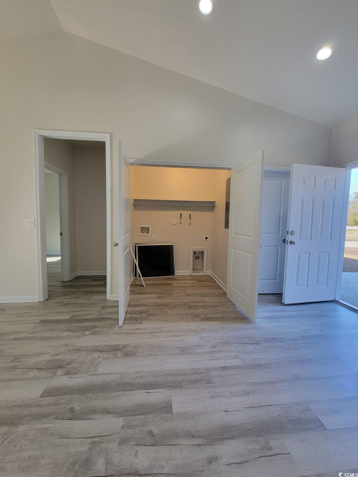 4967 Lyons Lane Longs, SC 29568 - Photo 7 of 9 Unfurnished living room with lofted ceiling, light wood-style floors, and recessed lighting