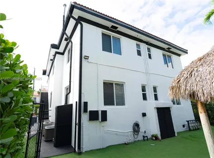 a view of backyard with barbeque grill and plants