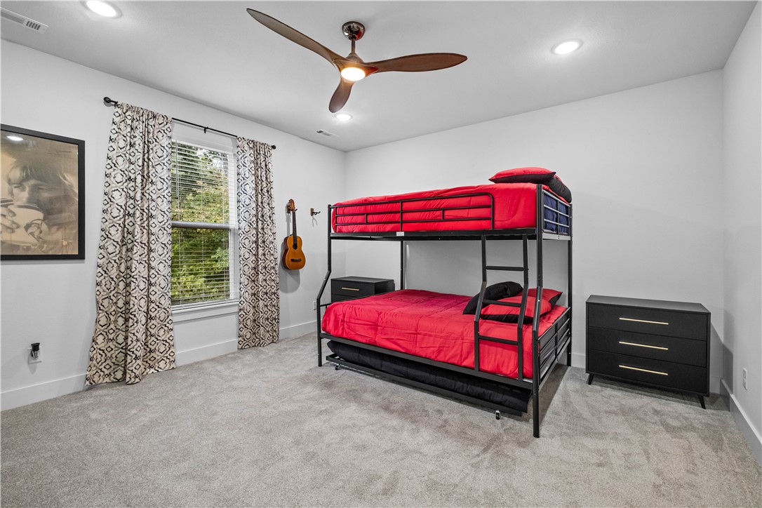 2055 Collins Drive Pea Ridge, AR 72751 - Photo 39 of 53 Recessed lighting, ceiling fan with wood-finish blades, and soft gray carpeting