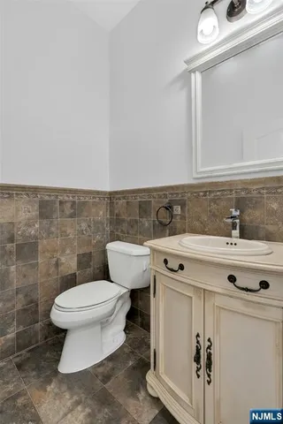 a bathroom with a sink toilet and mirror