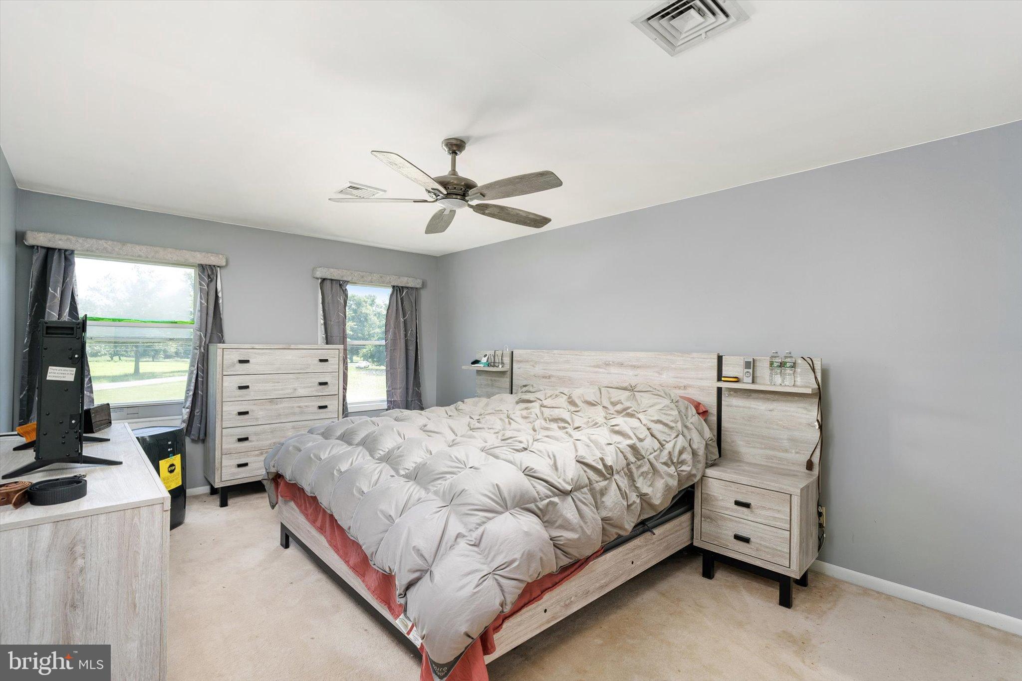 36 Allens Road Hightstown, NJ 08520 - Photo 18 of 43 a bedroom with a bed and a chandelier