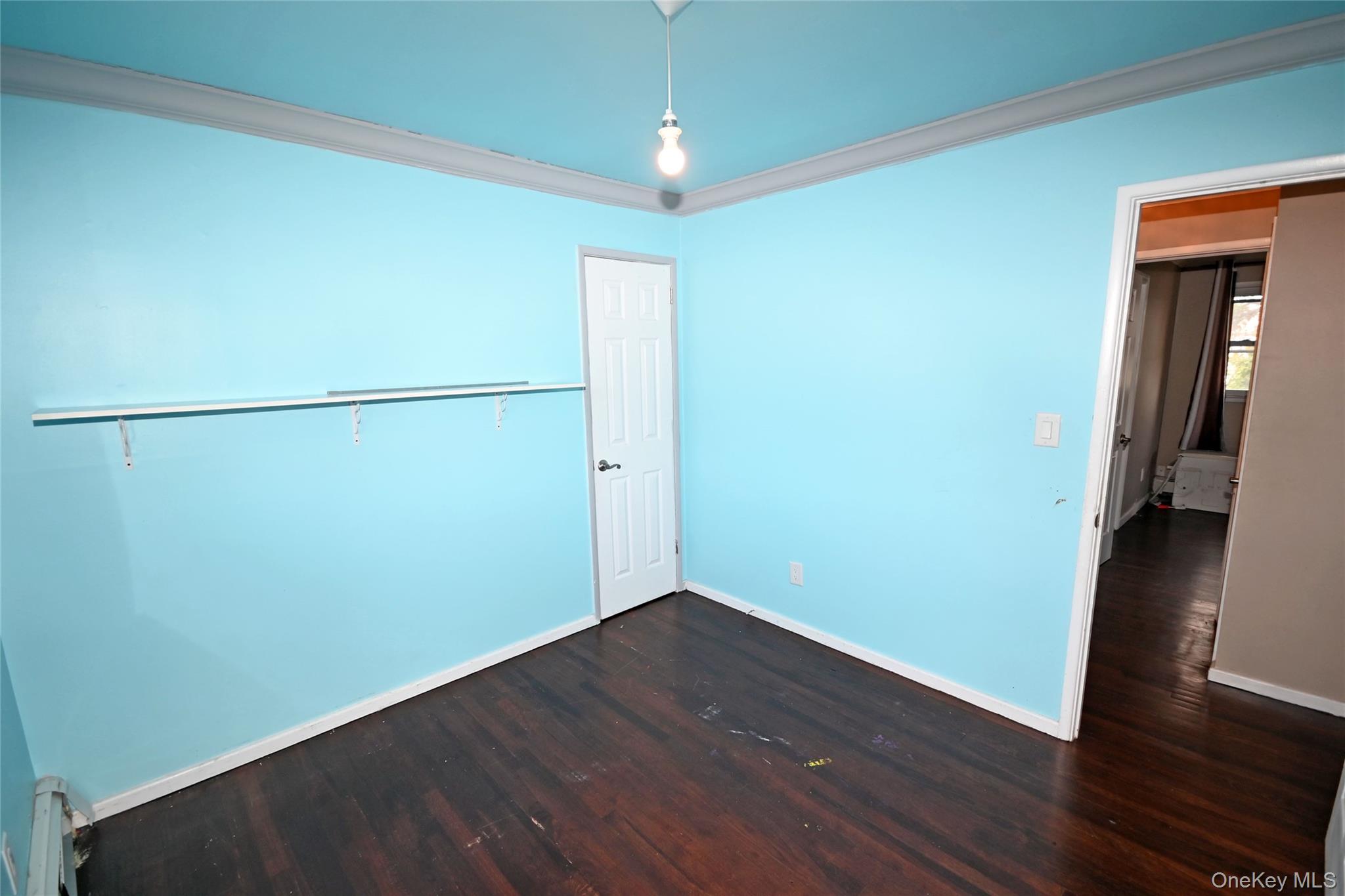 89 Osborne Road West Hempstead, NY 11552 - Photo 7 of 50 Unfurnished bedroom featuring crown molding and dark wood finished floors