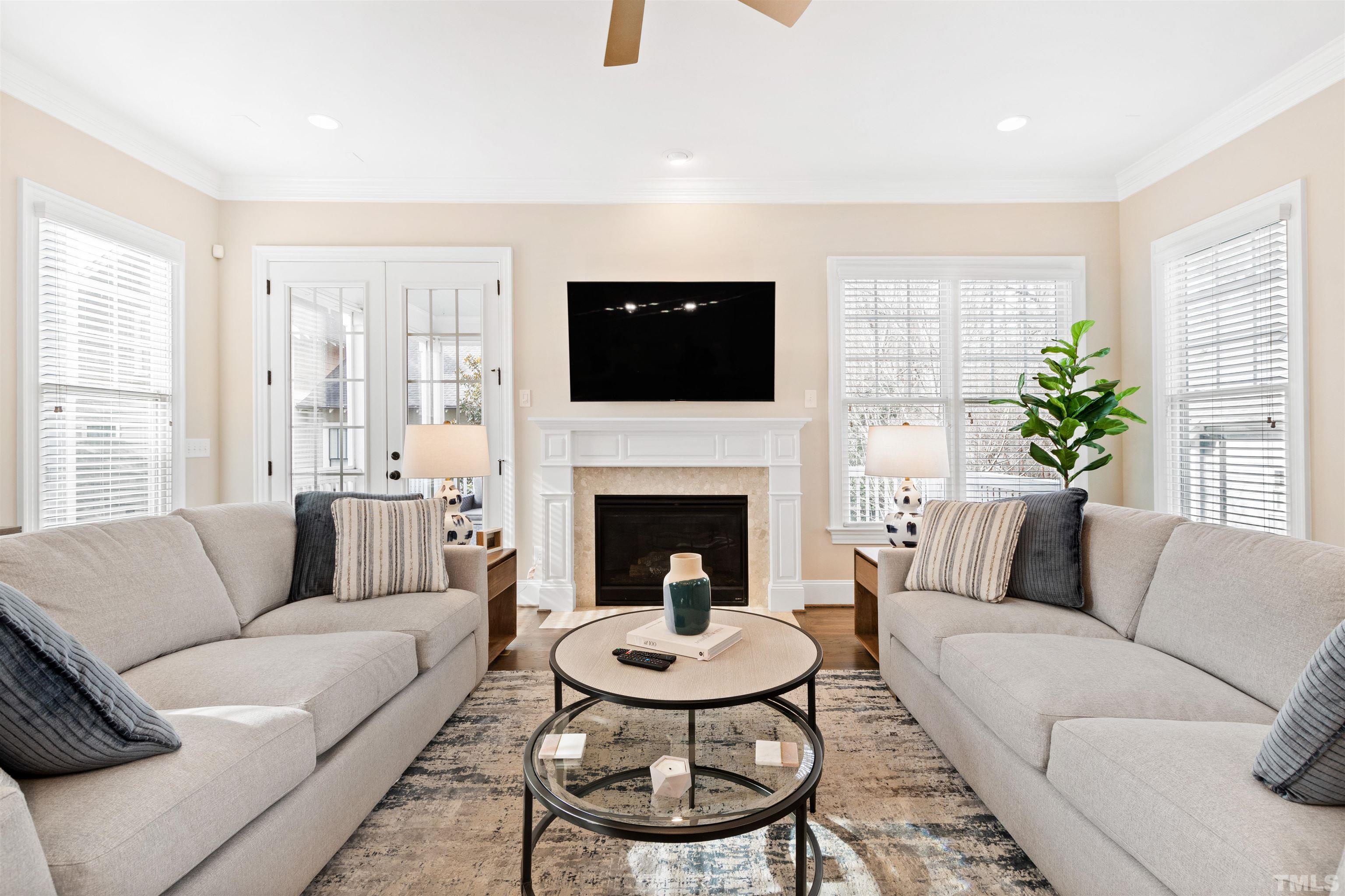 2005 Carroll Drive Raleigh, NC 27608 - Photo 20 of 52 a living room with furniture a flat screen tv and a fireplace