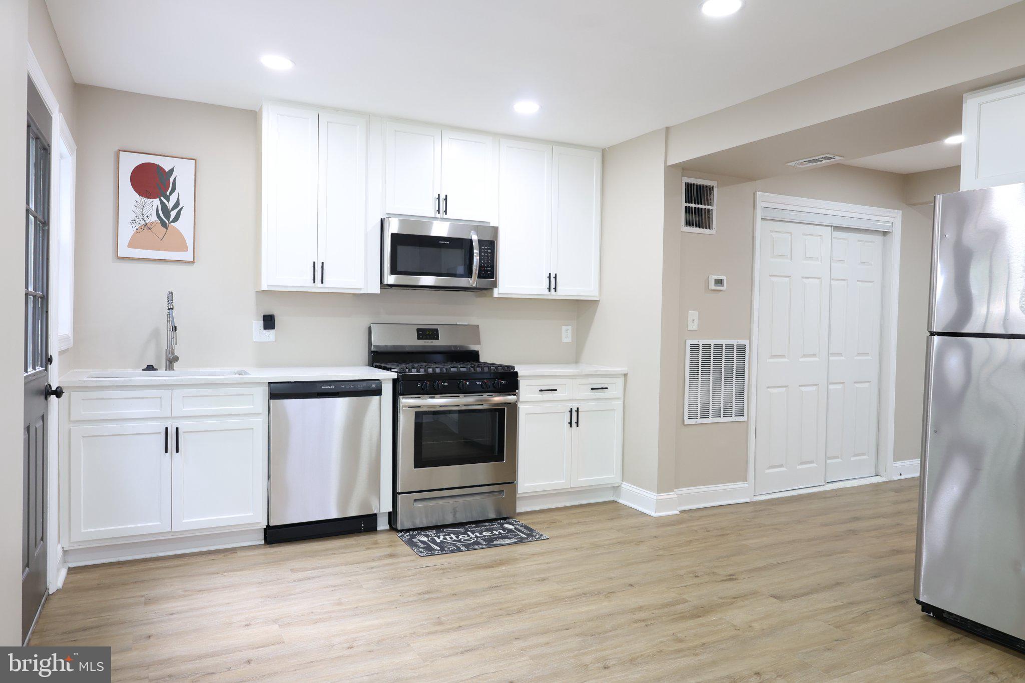 1316 Eastern Avenue Northeast Washington, DC 20019 - Photo 14 of 31 a kitchen with stainless steel appliances a white stove top oven a sink and a refrigerator