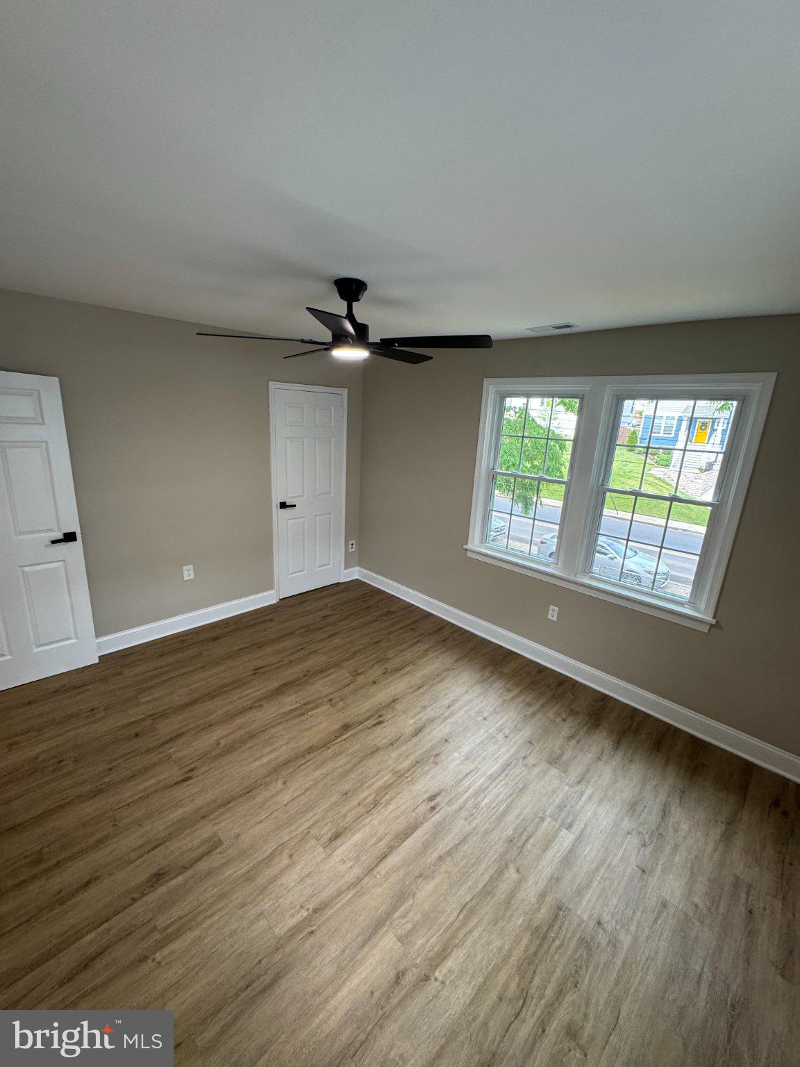 1316 Eastern Avenue Northeast Washington, DC 20019 - Photo 17 of 31 an empty room with wooden floor and windows