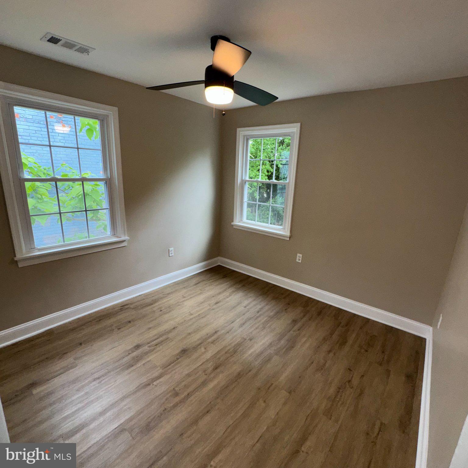 1316 Eastern Avenue Northeast Washington, DC 20019 - Photo 20 of 31 a view of an empty room with wooden floor and a window