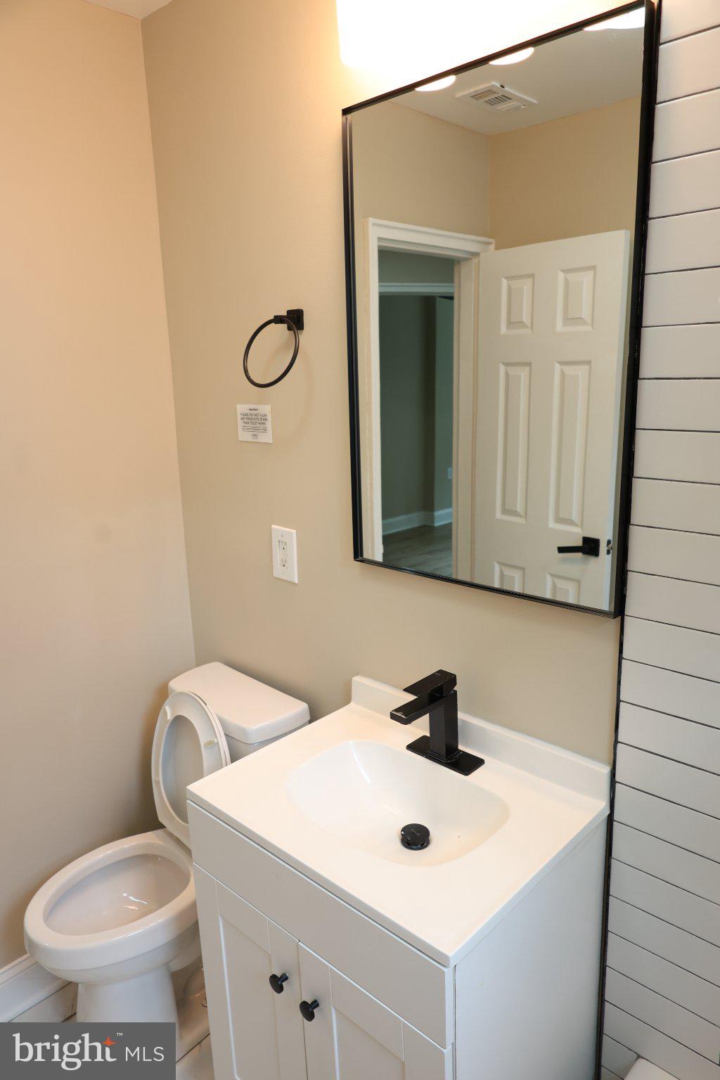 1316 Eastern Avenue Northeast Washington, DC 20019 - Photo 23 of 31 a bathroom with a sink a toilet and mirror