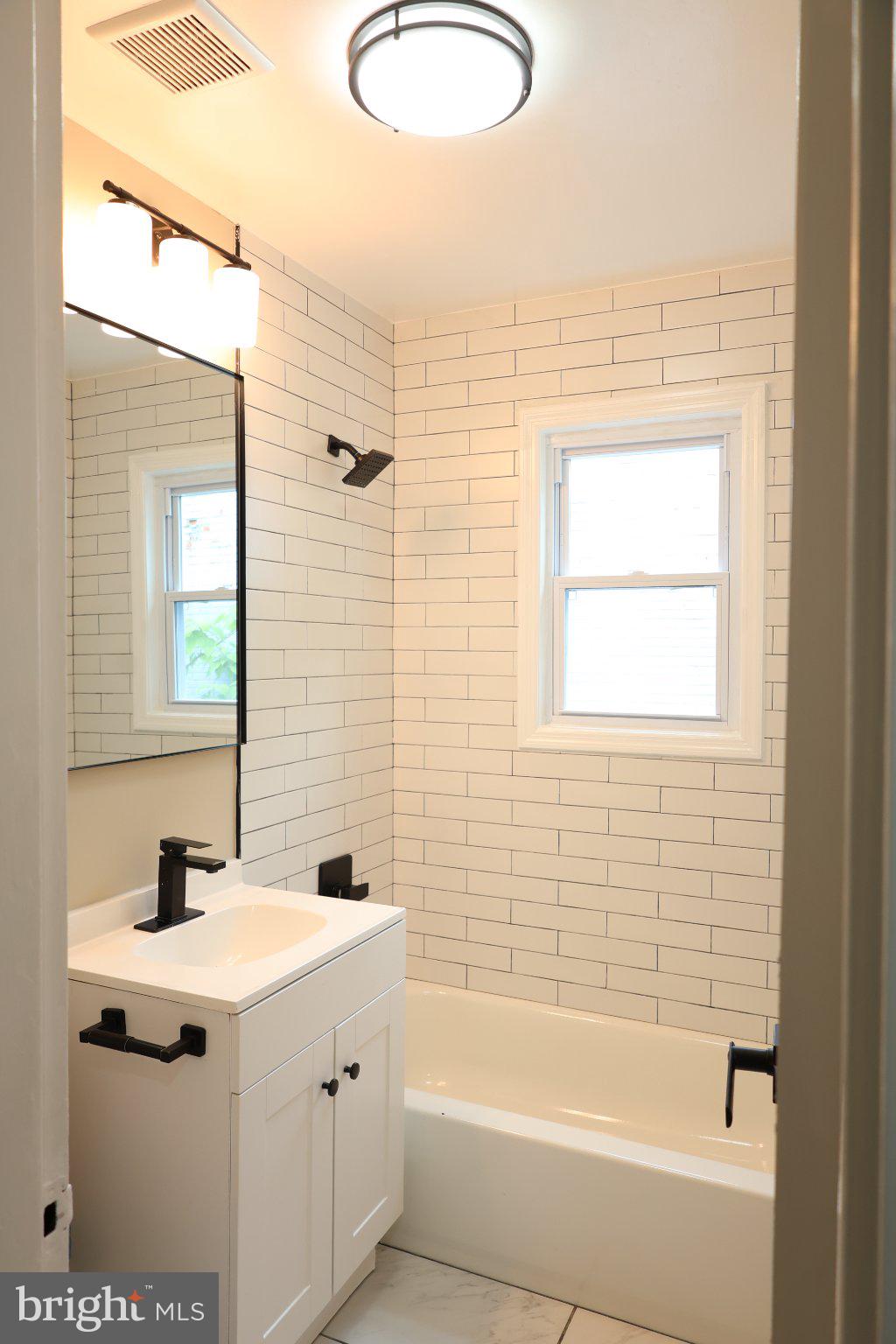 1316 Eastern Avenue Northeast Washington, DC 20019 - Photo 25 of 31 a bathroom with a sink mirror and a bathtub