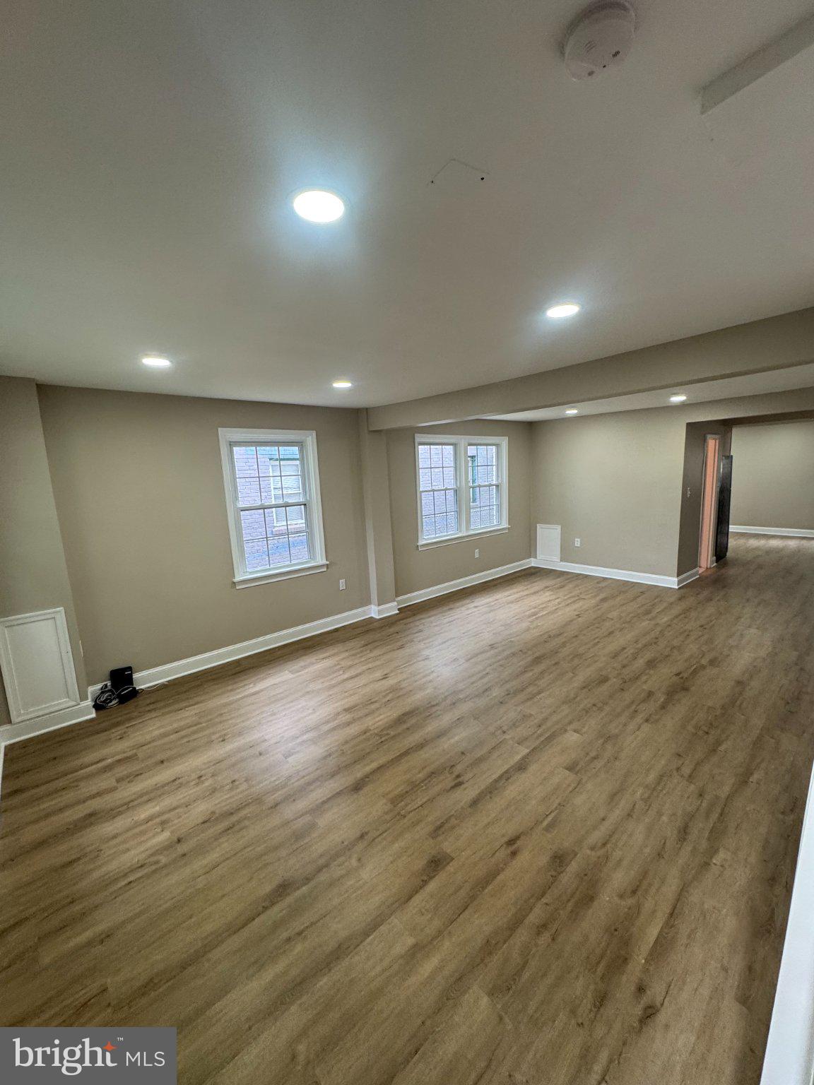 1316 Eastern Avenue Northeast Washington, DC 20019 - Photo 3 of 31 an empty room with wooden floor and windows