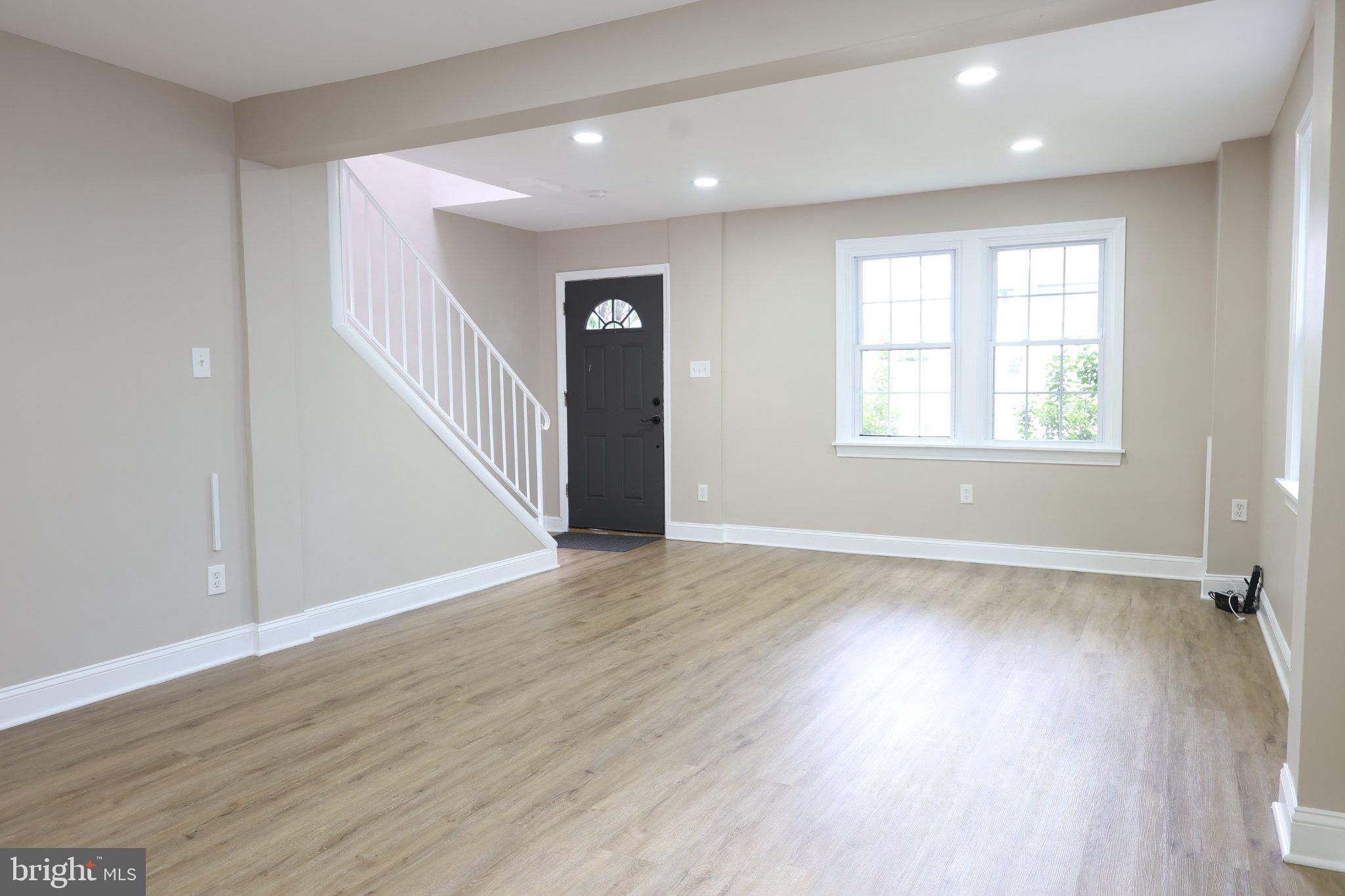 1316 Eastern Avenue Northeast Washington, DC 20019 - Photo 4 of 31 an empty room with wooden floor and windows