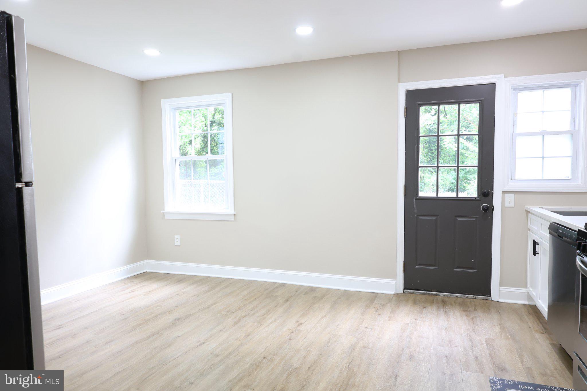 1316 Eastern Avenue Northeast Washington, DC 20019 - Photo 10 of 31 an empty room with wooden floor and windows