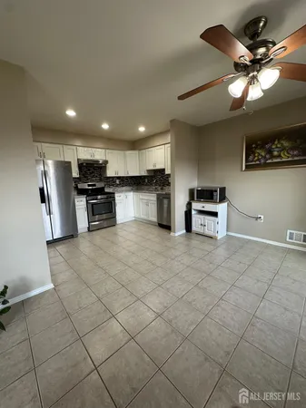 a view of kitchen with furniture and a ceiling fan
