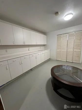 a kitchen with sink and cabinets
