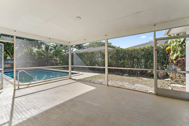 a view of an empty room with sliding glass door and mountain view
