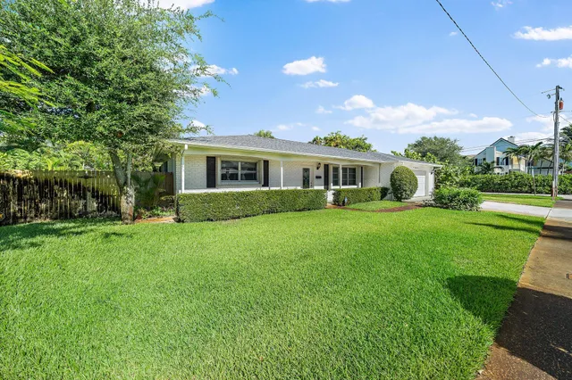 a view of house with yard and green space