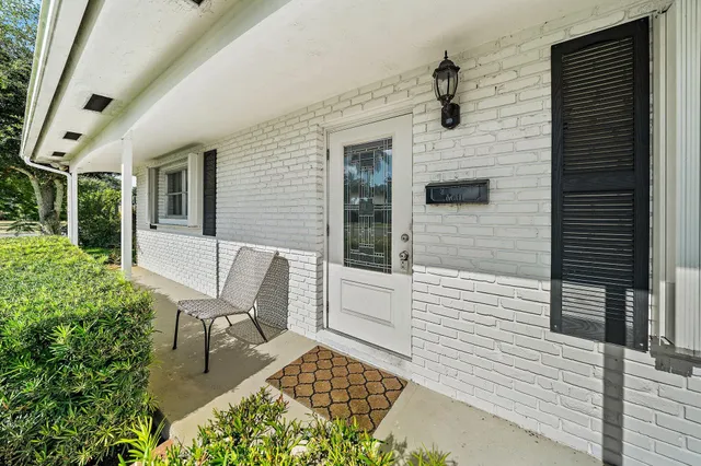 a front view of a house with outdoor seating