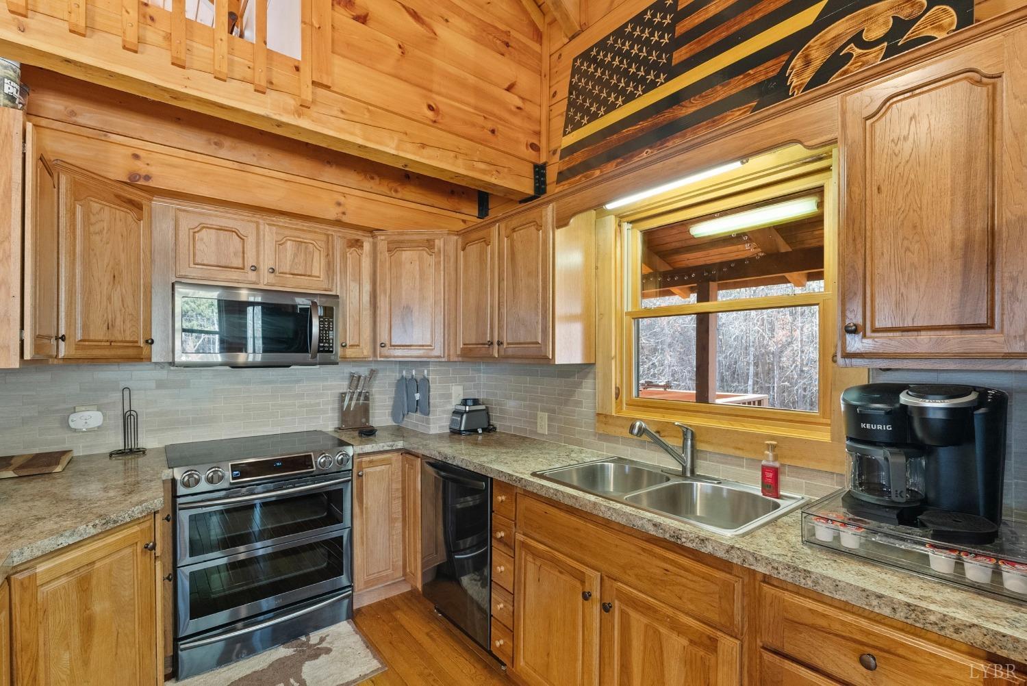 1069 Vineyard Road Spout Spring, VA 24538 - Photo 15 of 60 a kitchen that has a sink stove top oven and cabinets