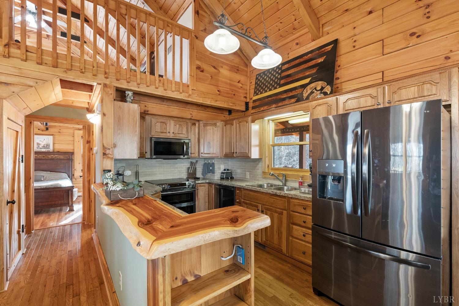 1069 Vineyard Road Spout Spring, VA 24538 - Photo 18 of 60 a kitchen with stainless steel appliances granite countertop a refrigerator a stove and a sink