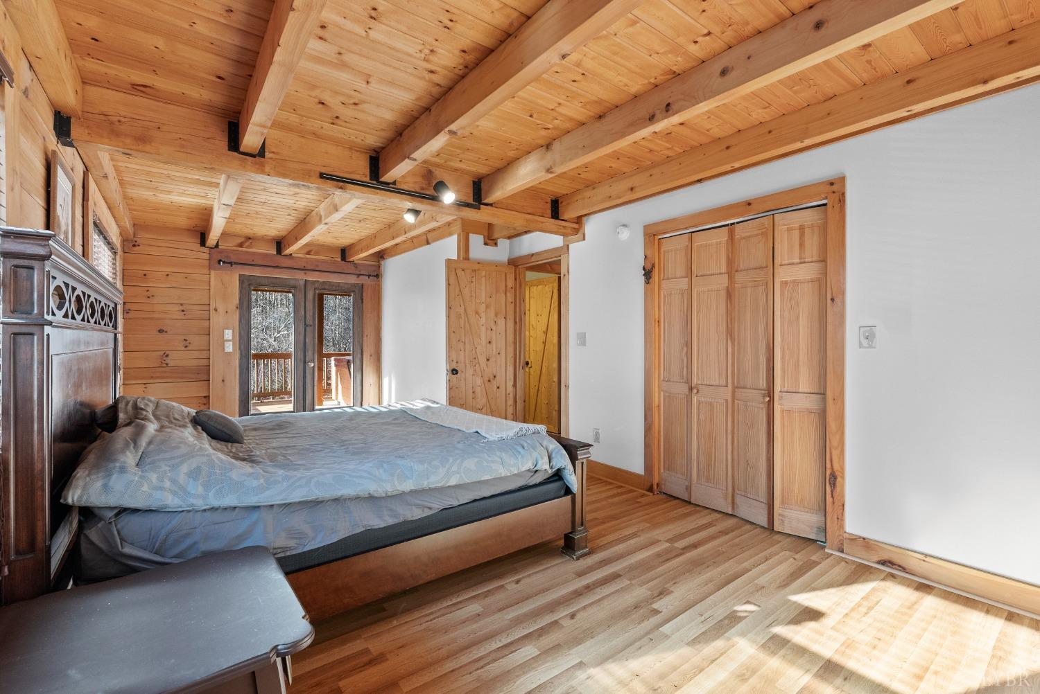 1069 Vineyard Road Spout Spring, VA 24538 - Photo 23 of 60 a bed sitting in a spacious bedroom next to a window