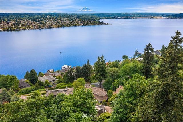 an aerial view of a houses with a lake view