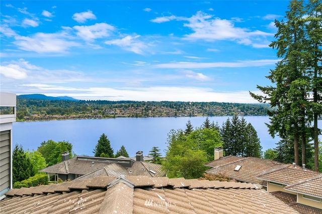a view of a lake with houses in the back