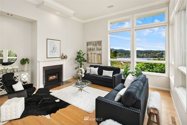 a living room with furniture fireplace and a large window