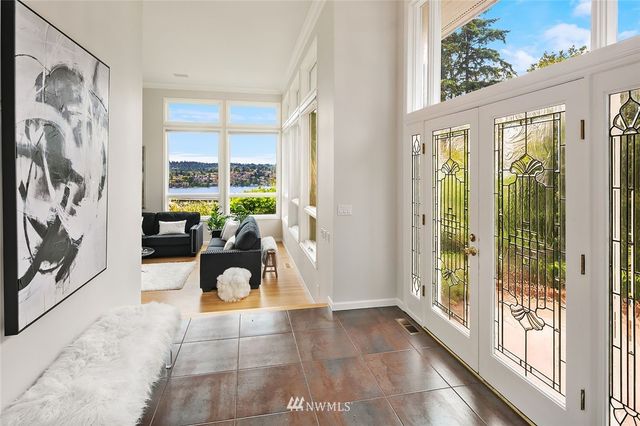 a living room with furniture and a large window with outer view